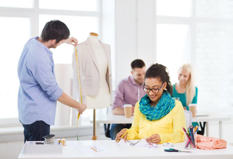 Smiling Fashion Designers Working in Office Stock Image - Image of ...