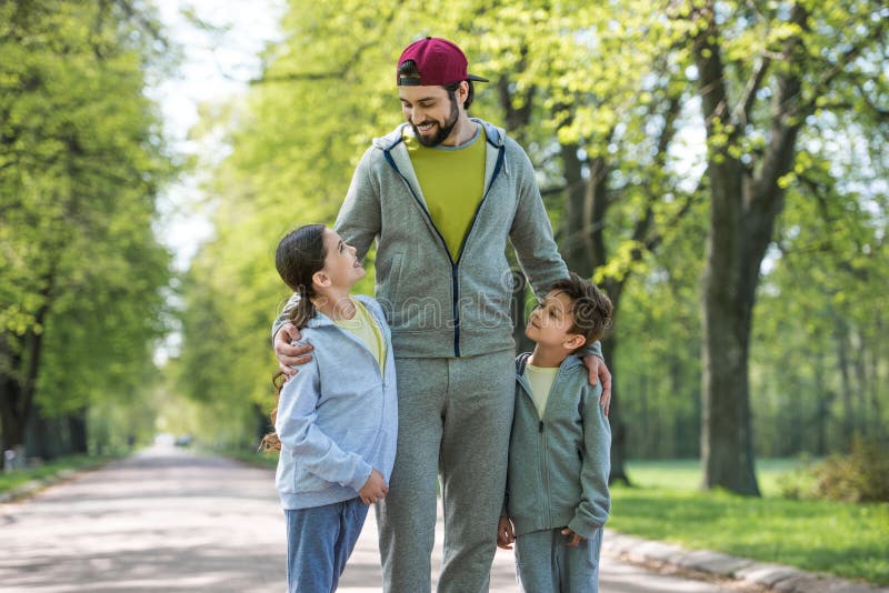 smiling father embracing daughter and son royalty free stock photo smiling father embracing daughter and son royalty free stock photo