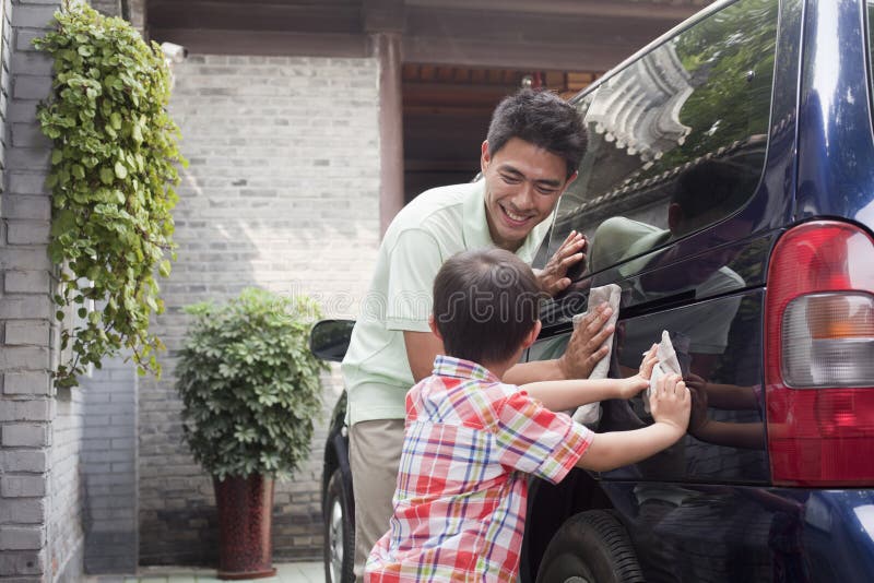 Smiling Father and Son Clean their Minivan Together. Single mini stock images, royalty-free photos and pictures