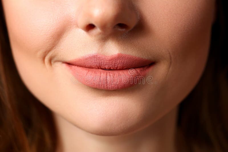 Smiling female closed red lips closeup