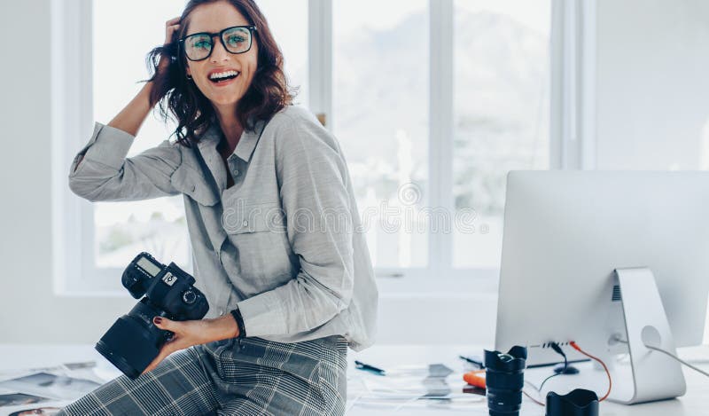 Photographer at the desk, office gadgets and object lens Stock Photo by  halfpoint