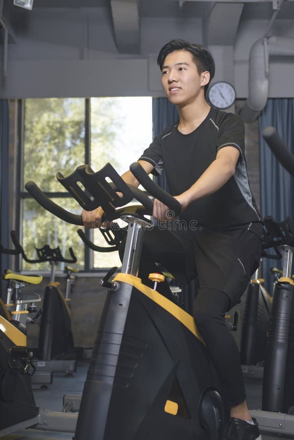 Asian Men in the Gym To Ride a Bicycle. Stock Image Image of muscular