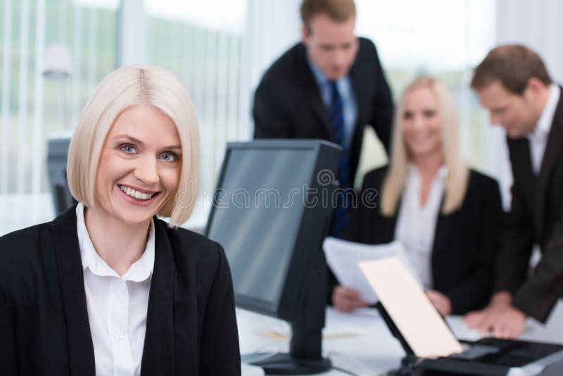 Smiling friendly businesswoman in the office royalty free stock photography Smiling friendly businesswoman in the office royalty free stock photography