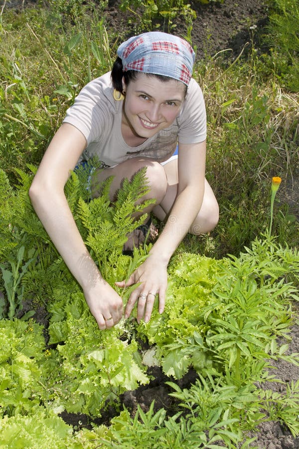 Smiling gardener in vegetable garden.