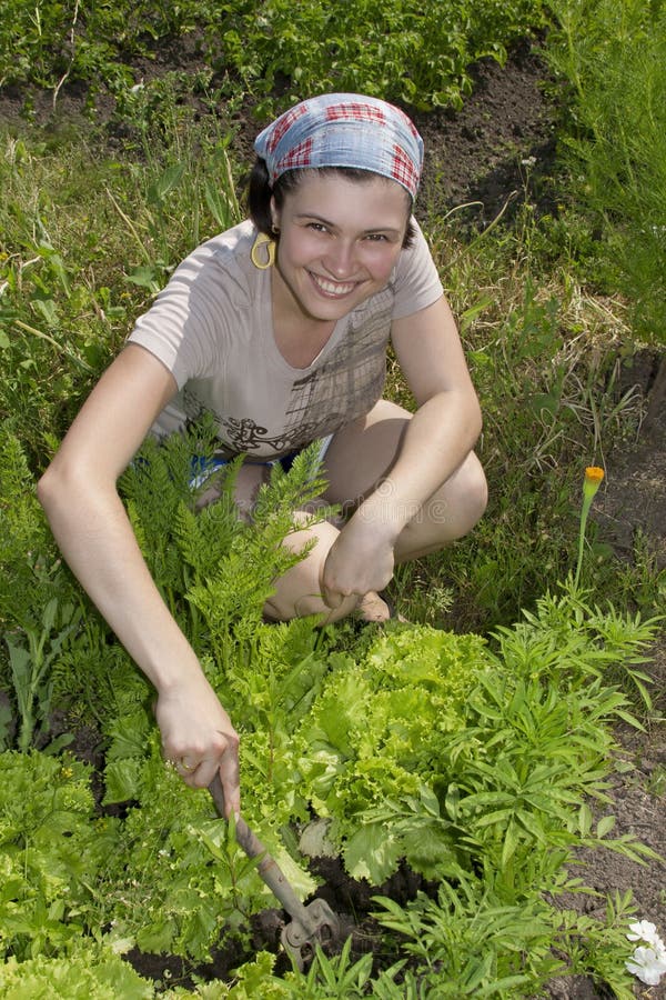 Smiling gardener in vegetable garden.