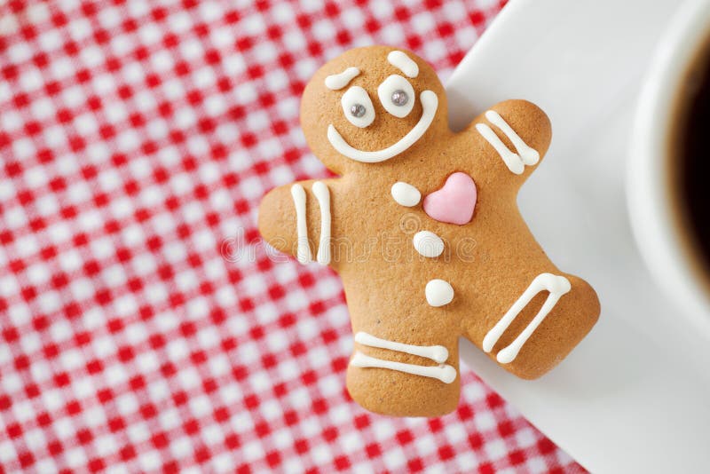 Smiling gingerbread man and coffee cup stock photography