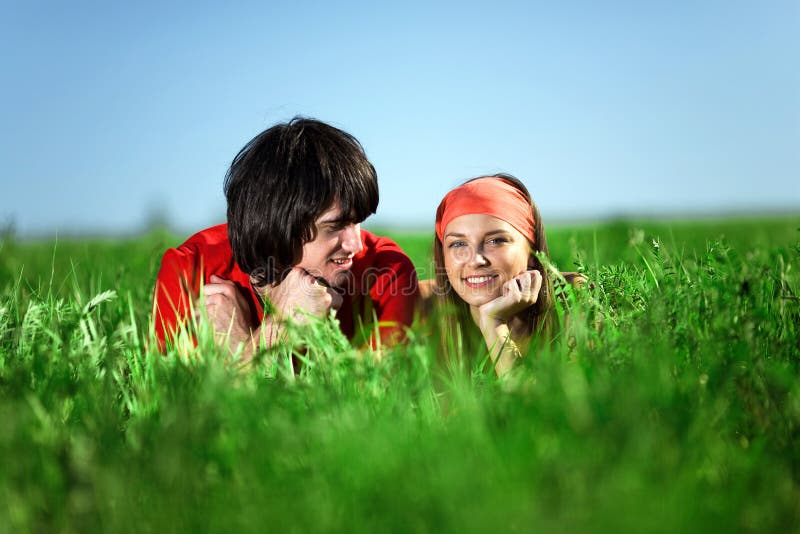 Smiling girl with boy on grass