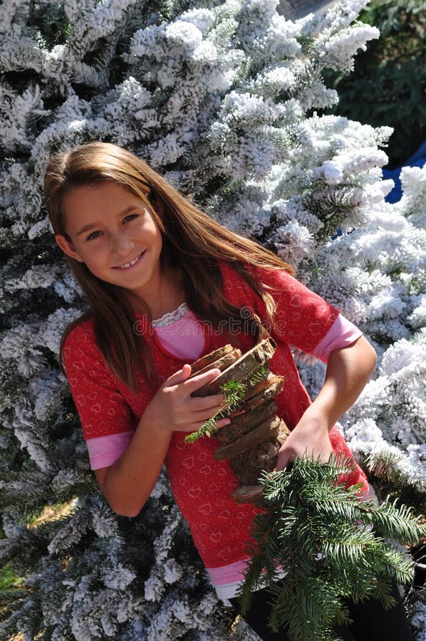 Smiling girl in Christmas tree lot
