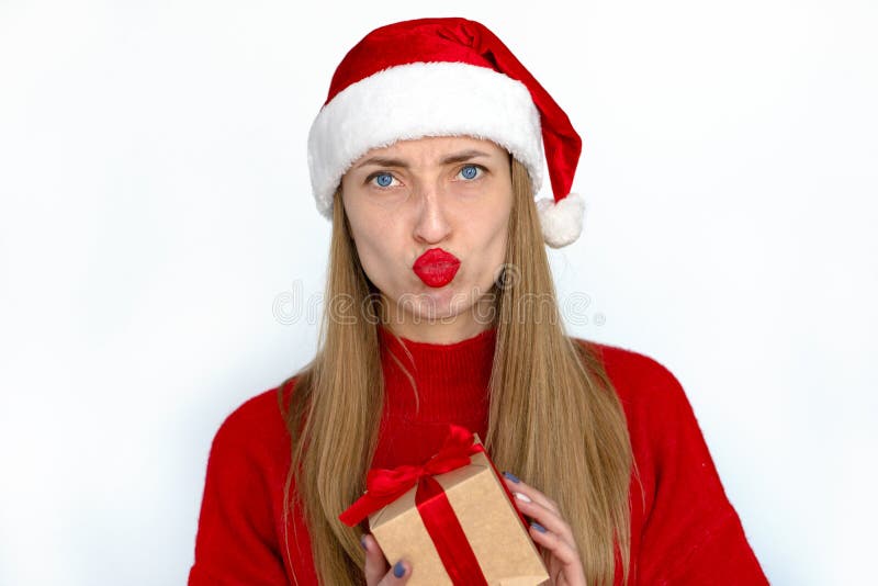 Smiling girl is holding a Christmas present. royalty free stock photos