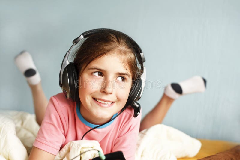 Smiling girl listens to music