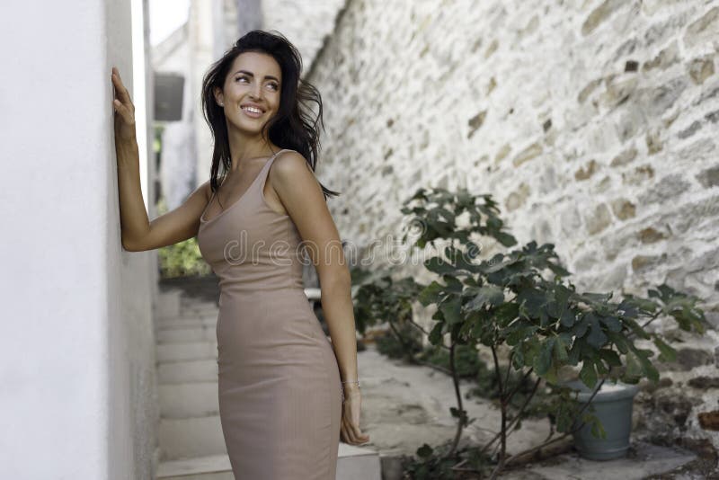 Smiling Girl Standing Near the Old Stone Wall picture