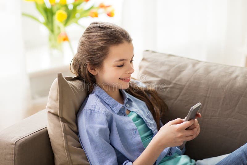 Smiling Girl Texting on Smartphone at Home Stock Photo - Image of ...