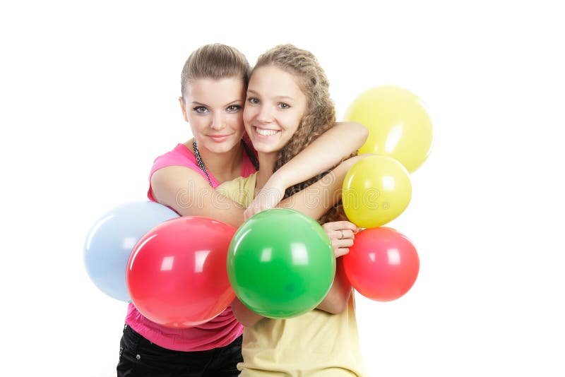 Smiling girls with balloons over white