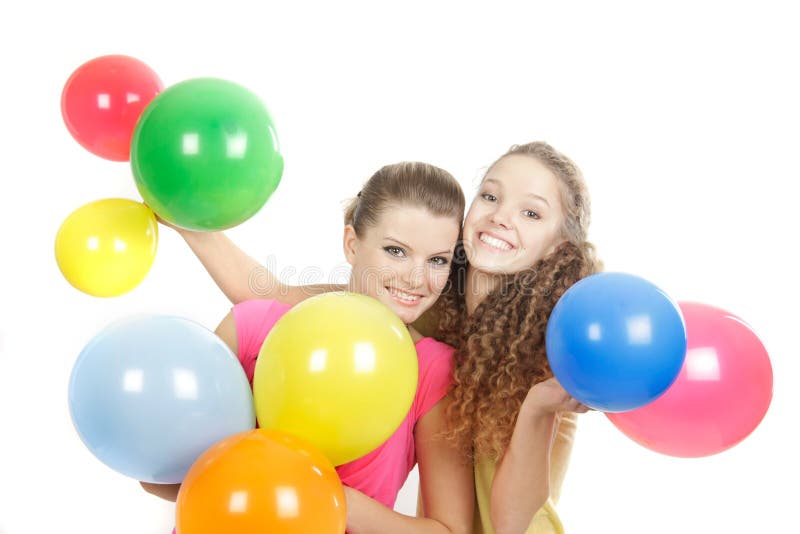 Smiling girls with balloons over white