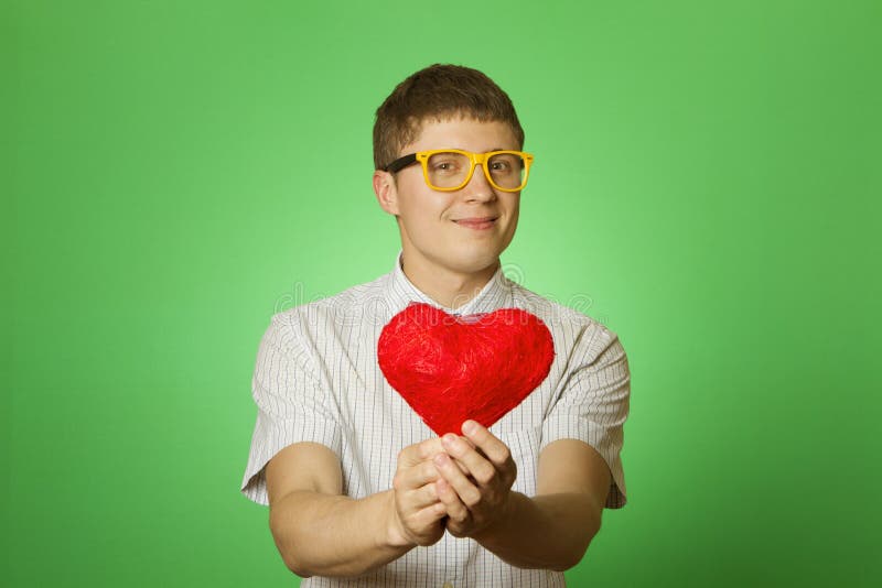 Smiling guy holding heart shape