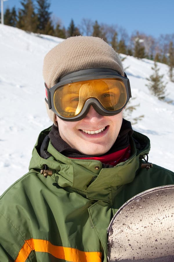 Smiling guy with snowboard