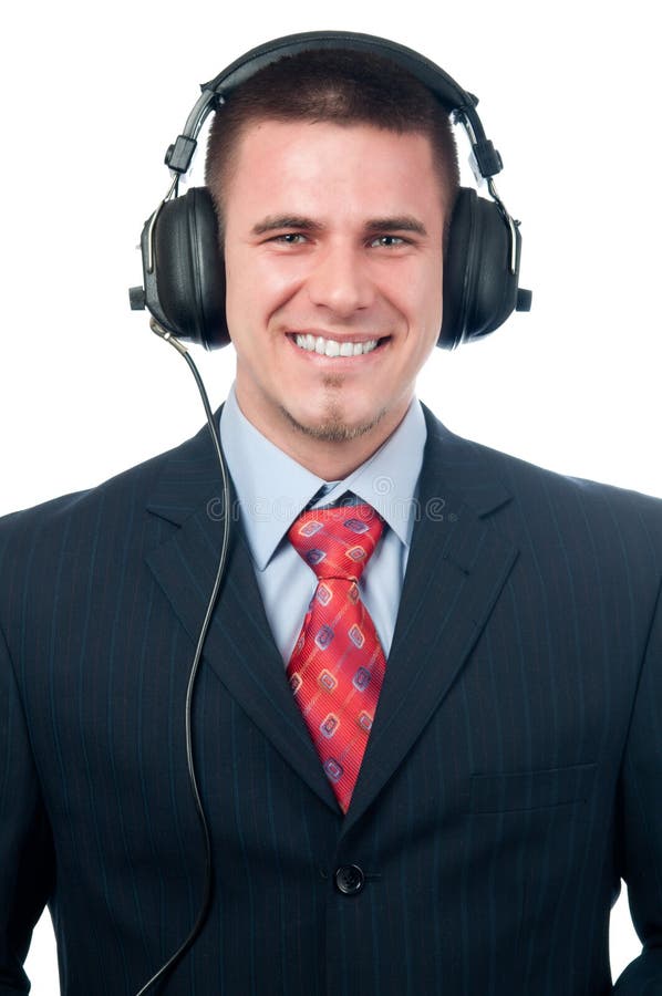 Smiling handsome businessman listening to music