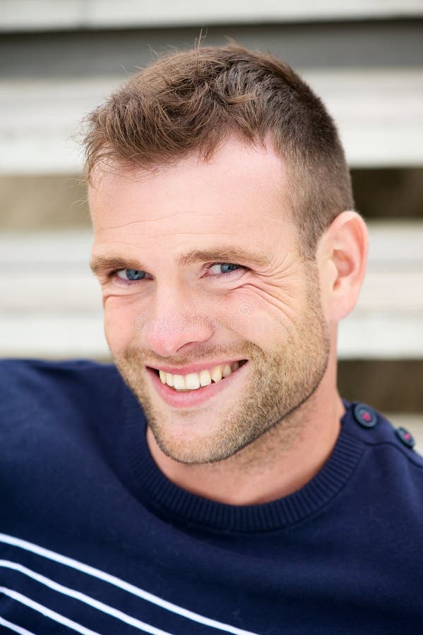 Smiling Man Walking in City with Cell and Suitcase Stock Photo Image