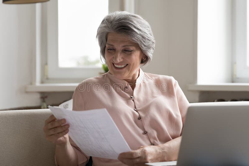 Smiling Older Woman Enjoy Good News In Paper Letter Document Stock