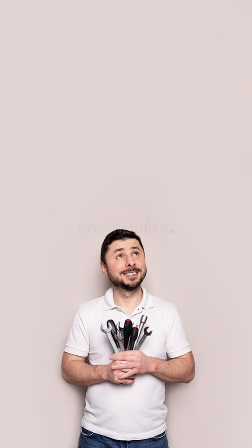 Smiling man with bouquet of wrenches and screwdrivers royalty free stock photography