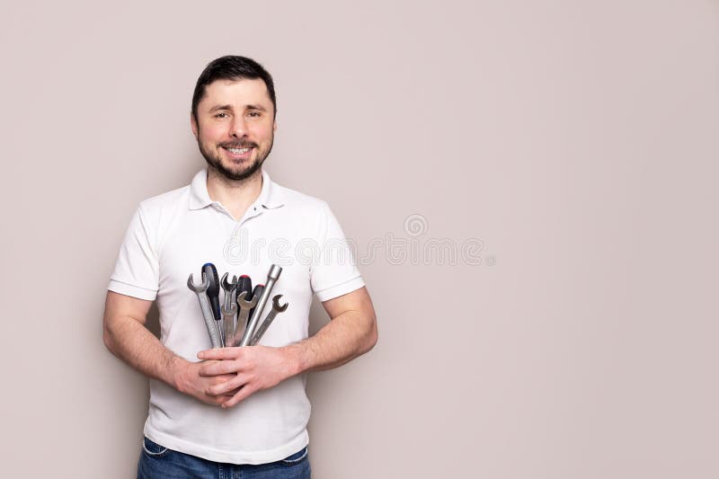 Smiling man with bouquet of wrenches and screwdrivers royalty free stock photos