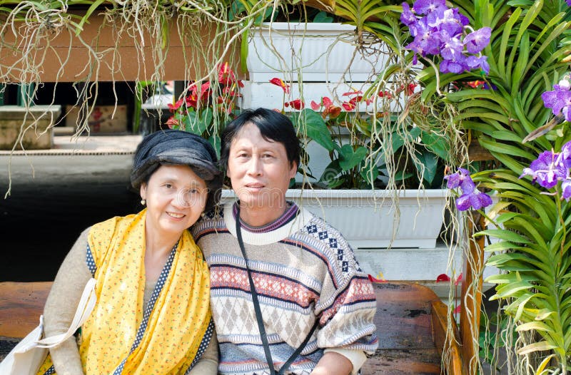 Smiling happy seniors couple in garden