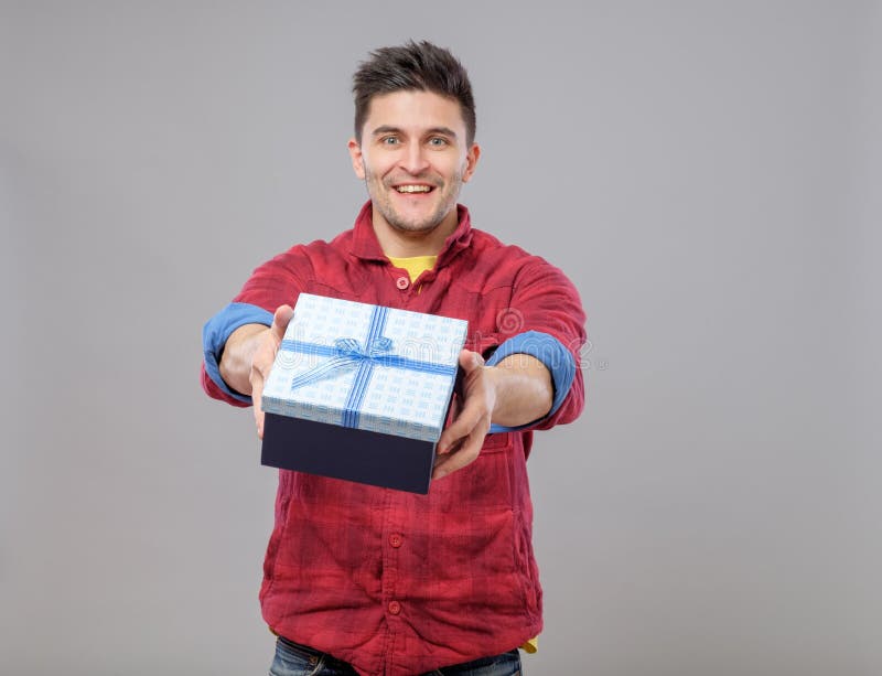 Smiling Happy Young Man Presenting a Gift Stock Photo - Image of ...