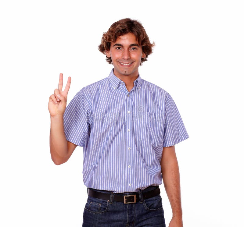 Smiling hispanic man with finger victory gesture