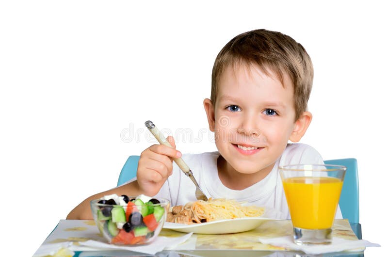 Smiling Joyful Boy Sitting at the Dinner Table and Looking at Th Stock