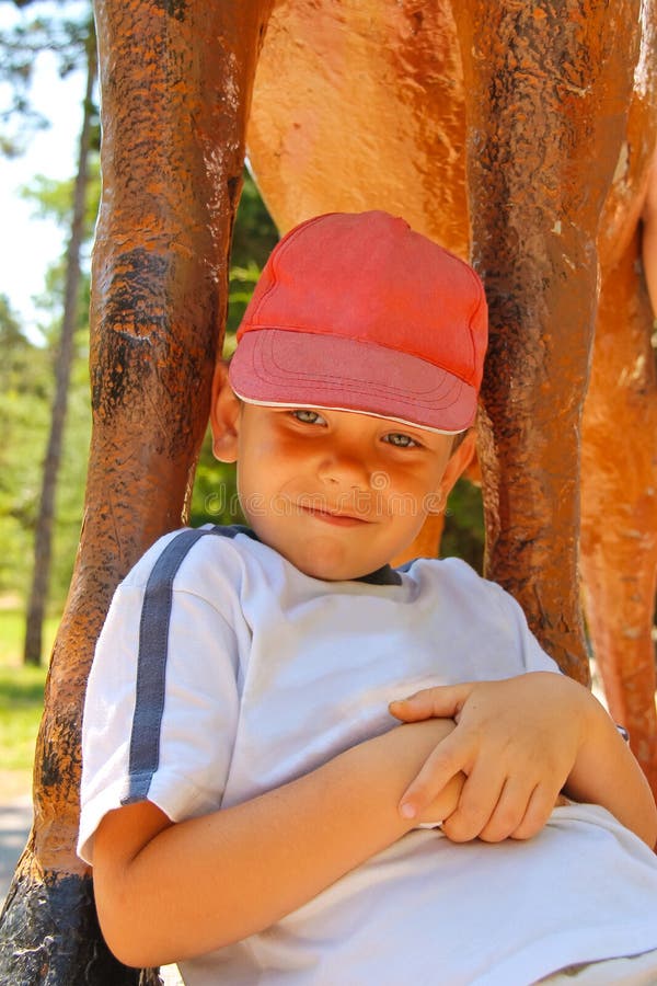 Smiling kid wearing a cap in the park