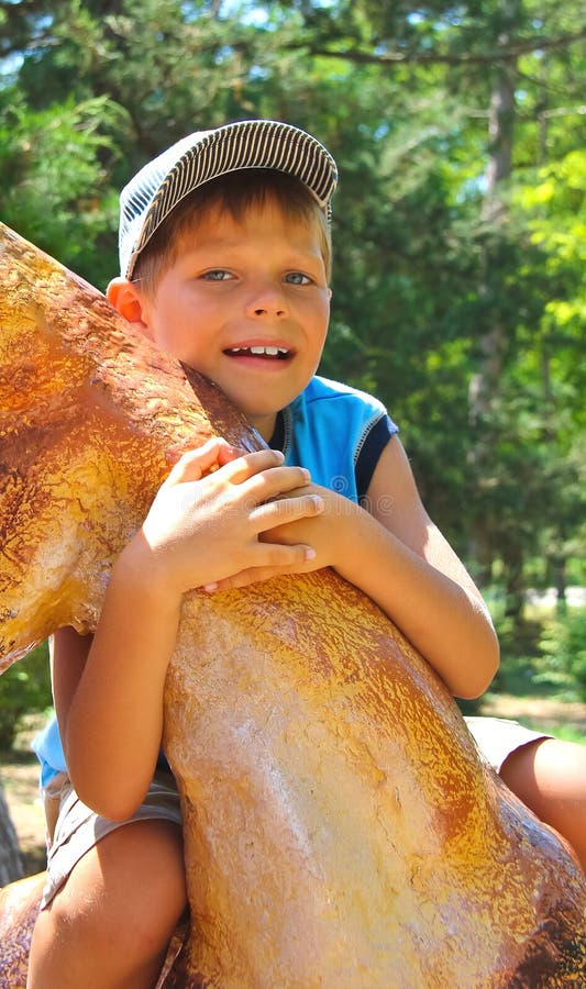 Smiling kid wearing a cap in park