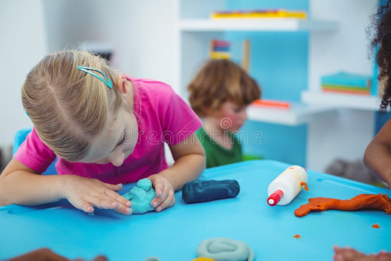 Smiling Kids Using Modelling Clay Stock Photo - Image of shaping