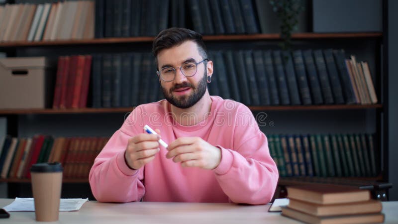 Smiling Latino bearded man blogger talking business educational information at library desk stock footage