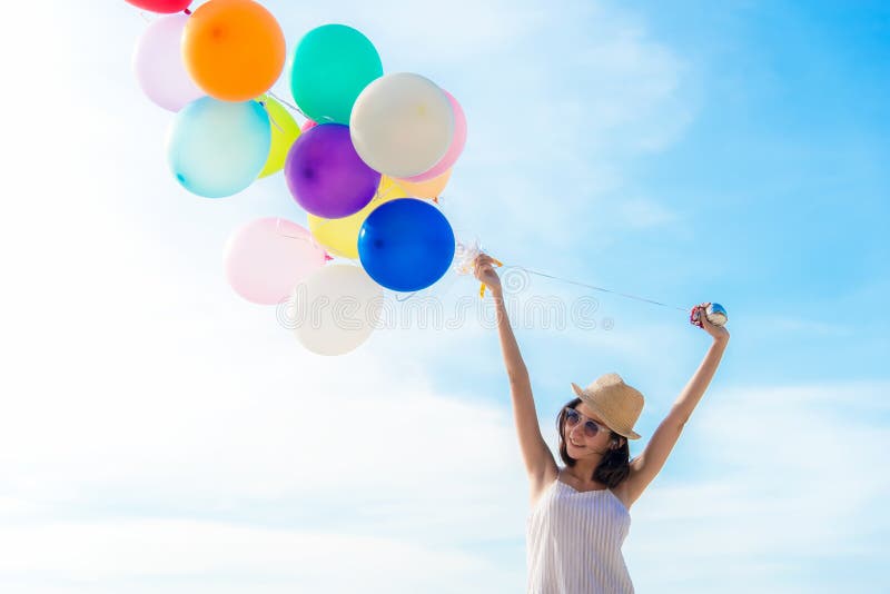 Smiling lifestyle asian woman chill hand holding balloon on the beach. Relax and Enjoy in summer holiday. royalty free stock photos Smiling lifestyle asian woman chill hand holding balloon on the beach. Relax and Enjoy in summer holiday. royalty free stock photos