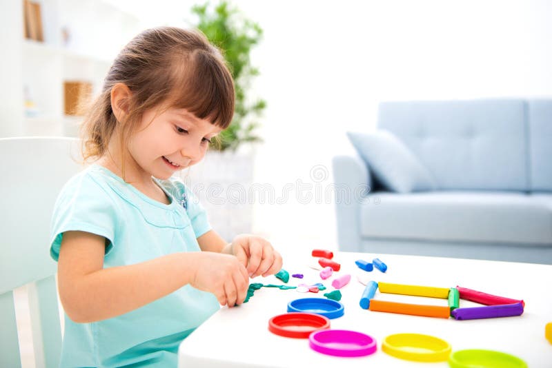 Smiling little beautiful girl sculpt new house of plasticine. Children creativity. Happy childhood. Housewarming dreams royalty free stock photos Smiling little beautiful girl sculpt new house of plasticine. Children creativity. Happy childhood. Housewarming dreams royalty free stock photos