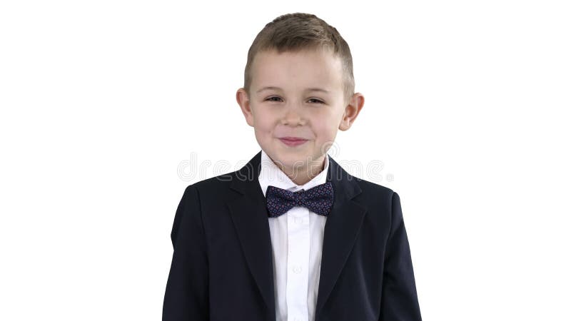 Smiling little boy in formal clothes standing on white background.