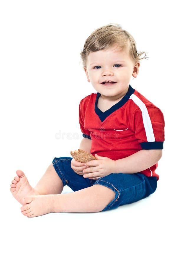 Smiling little boy holds on cookies