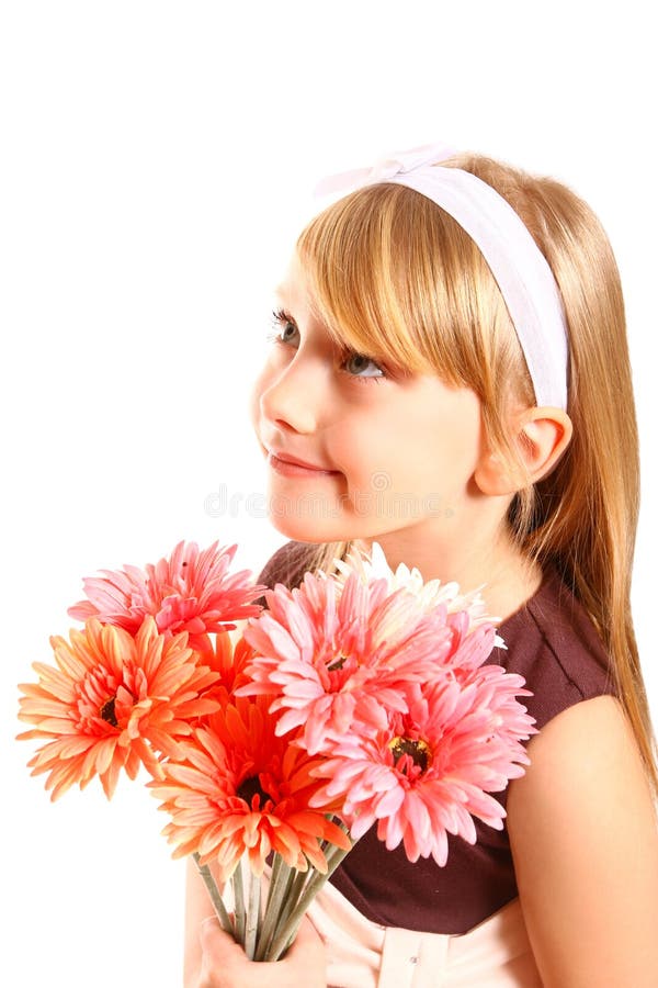 Smiling little girl with gerberas on a white background close-up