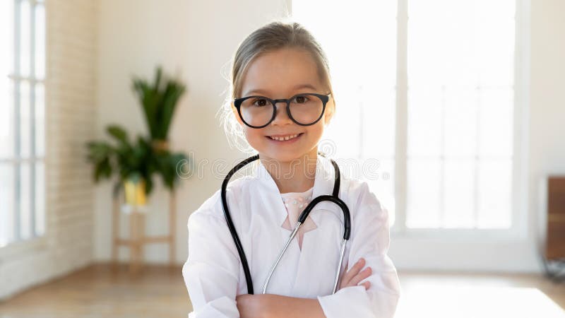 Smiling little girl in medical uniform act as doctor