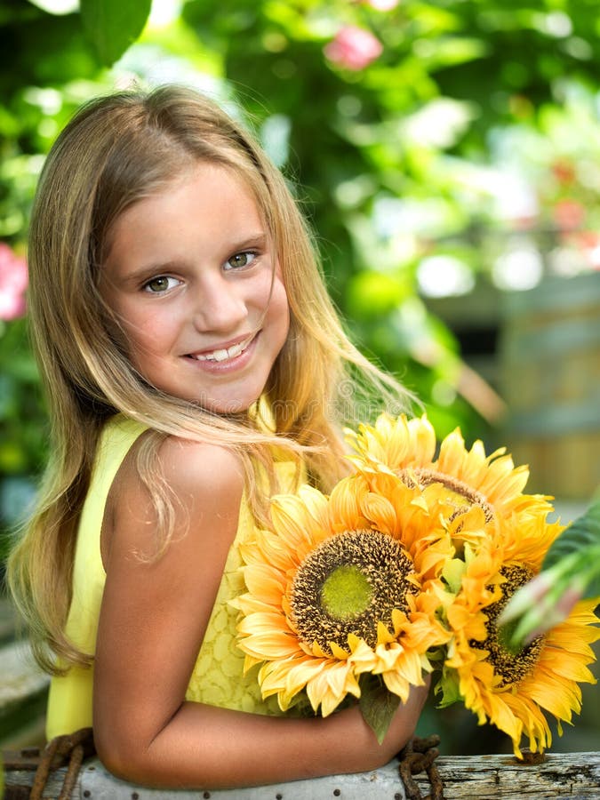 Smiling little girl with sunflower royalty free stock image Smiling little girl with sunflower royalty free stock image