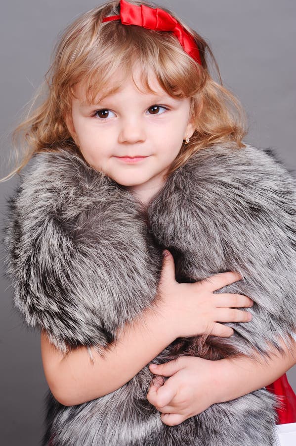 Smiling Little Girl Wearing Stylish Fur Clothes Stock Photo - Image of ...