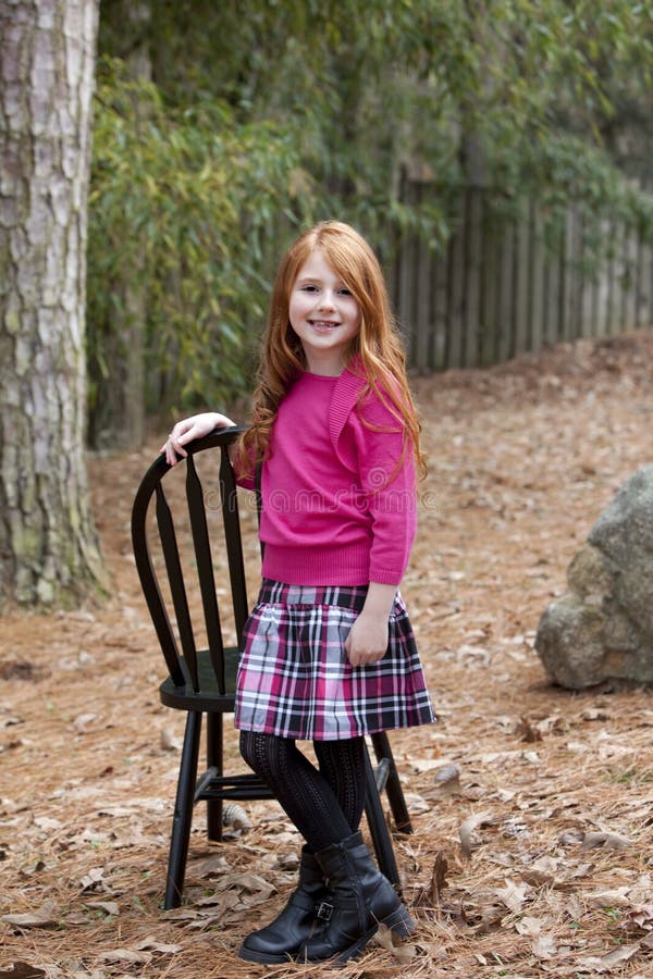 Smiling little red haired girl royalty free stock image