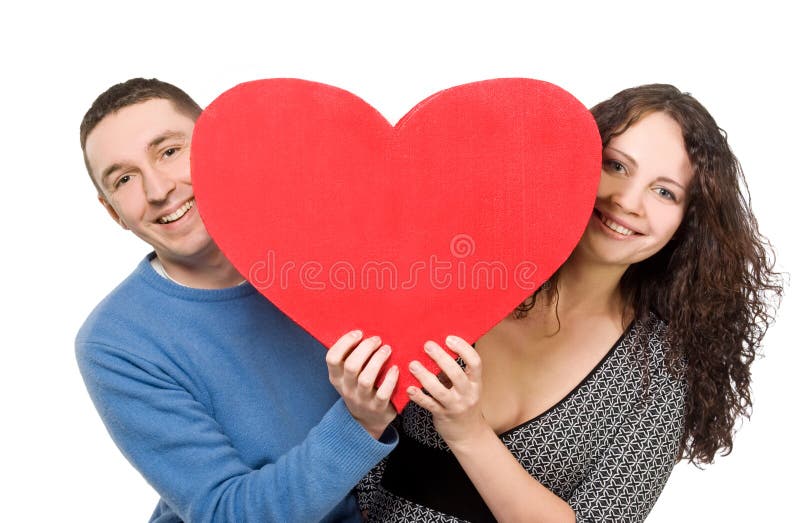 Smiling loving couple holding heart