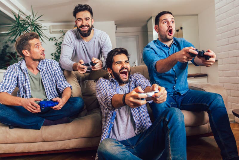 Male friends playing video games at home and having fun royalty free stock image Male friends playing video games at home and having fun royalty free stock image