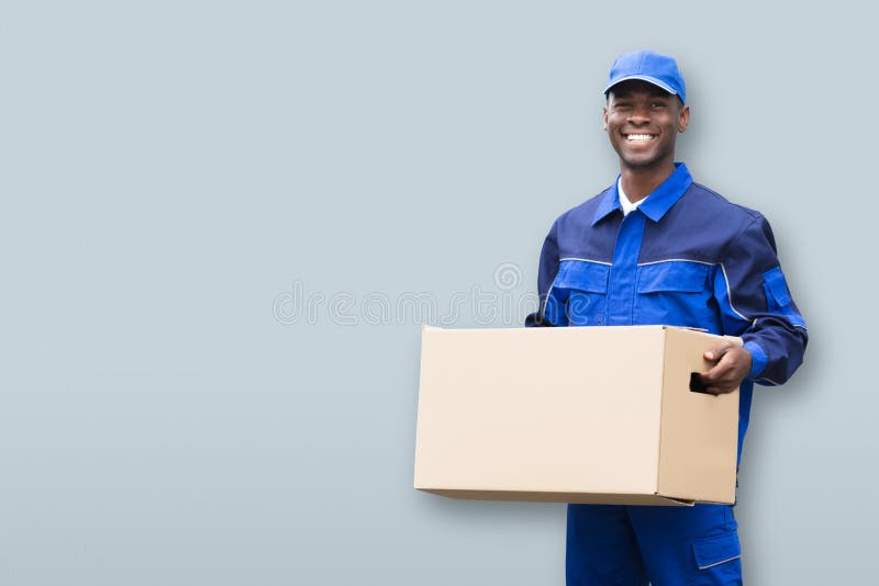 Smiling Male Mover Holding Package stock photo