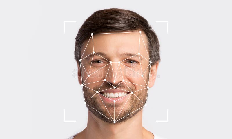 A smiling man is being analyzed by facial recognition technology stock photography