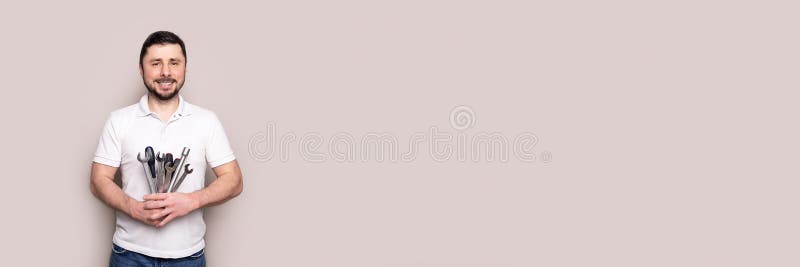 Smiling man with bouquet of wrenches and screwdrivers banner royalty free stock photos