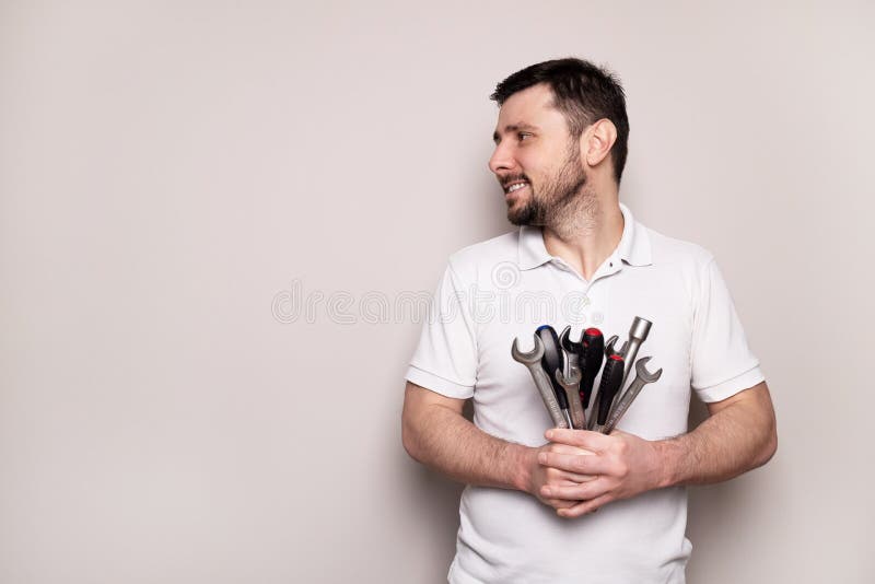 Smiling man with bouquet of wrenches and screwdrivers stock images