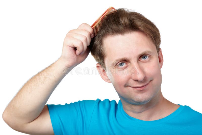 Smiling man combs his hair stock image. Image of cute 26281865