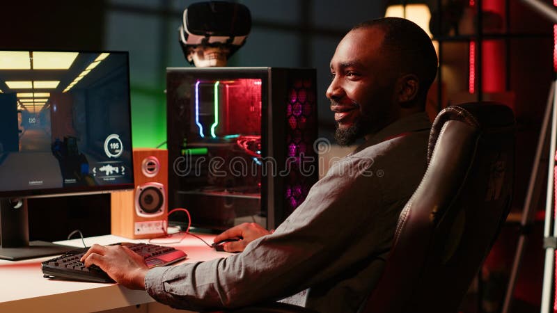 Smiling man playing video game, enjoying day off stock photo